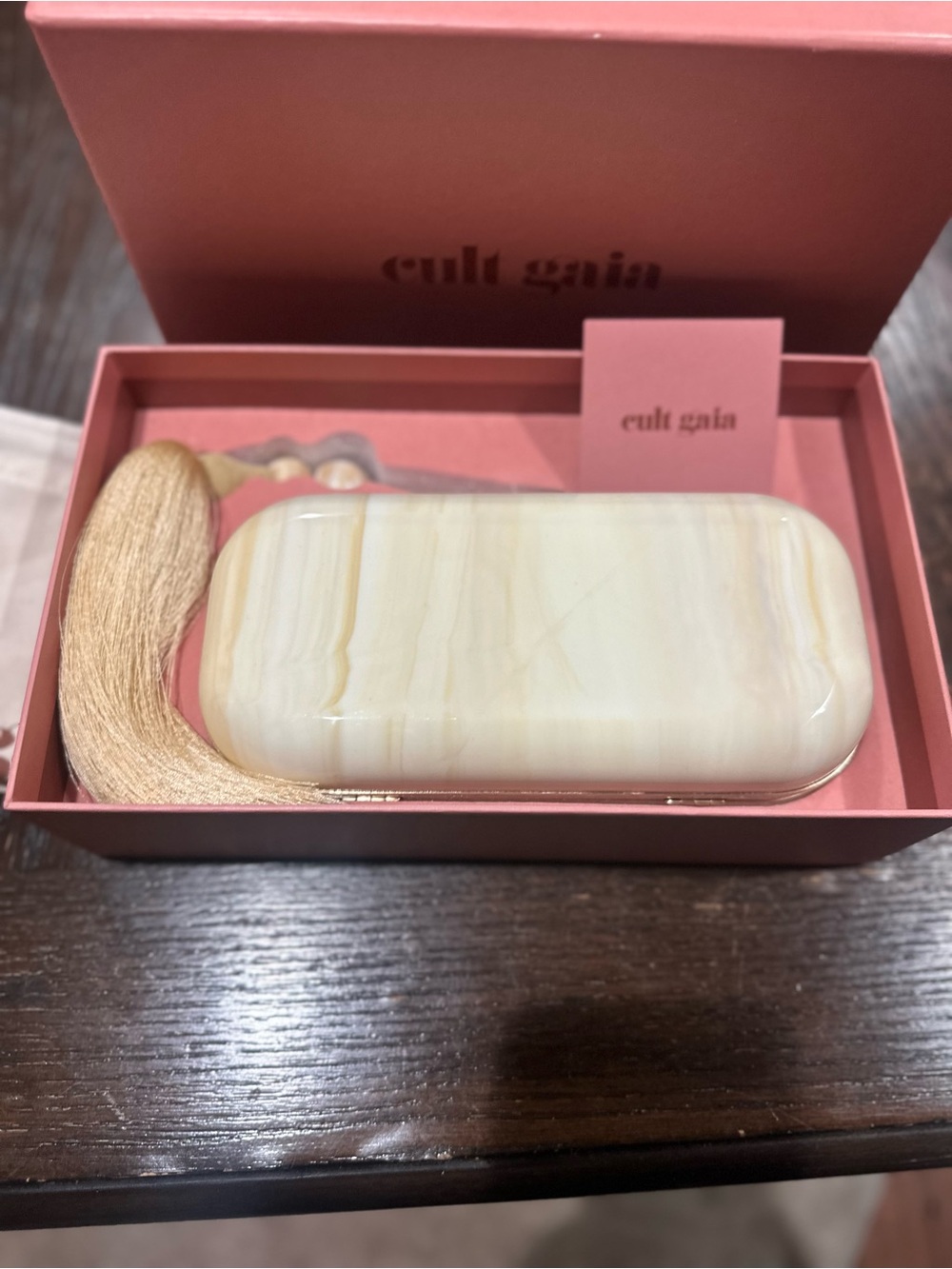 cult gaia cream marbled resin clutch with gold tassel